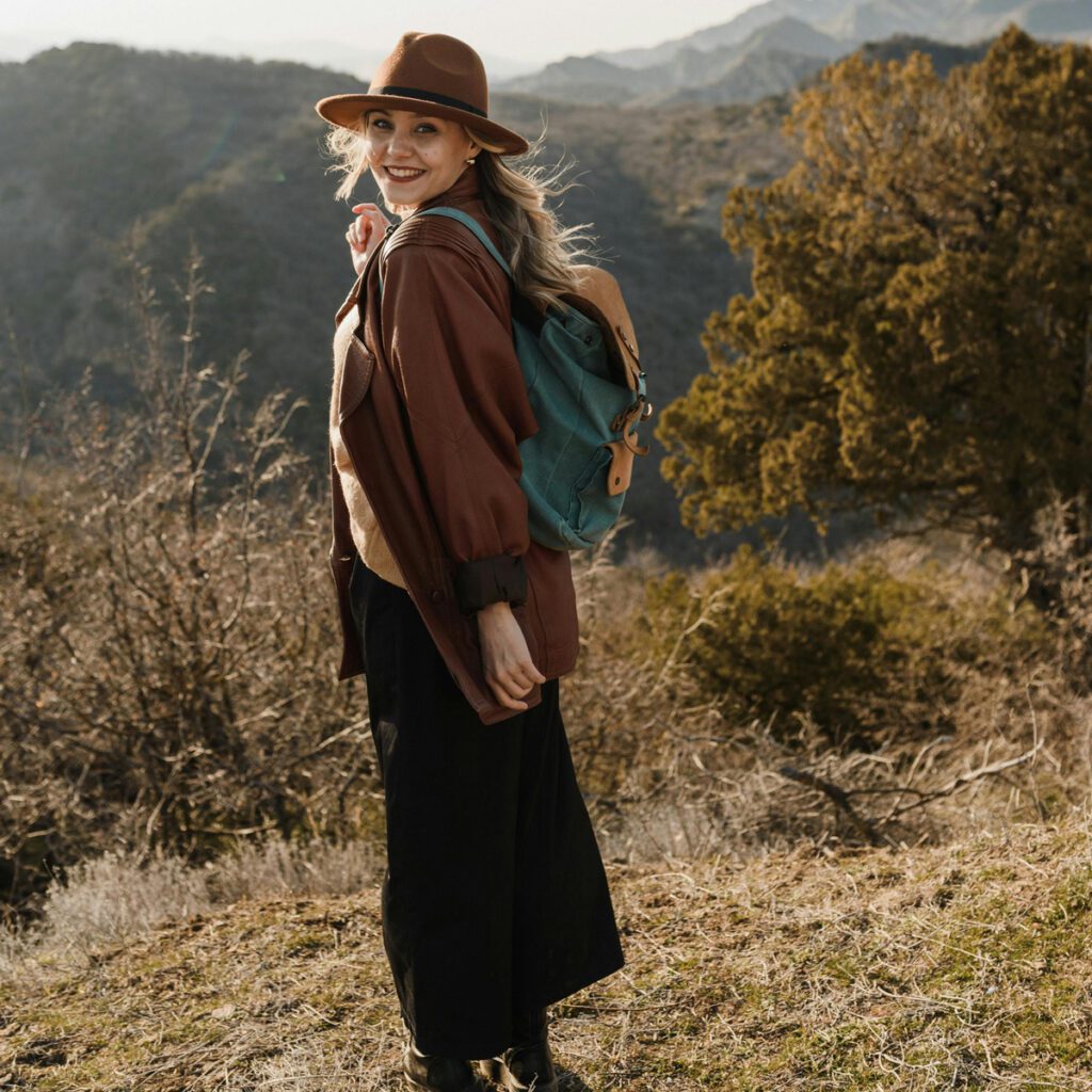 A lady smiling geared for a hike