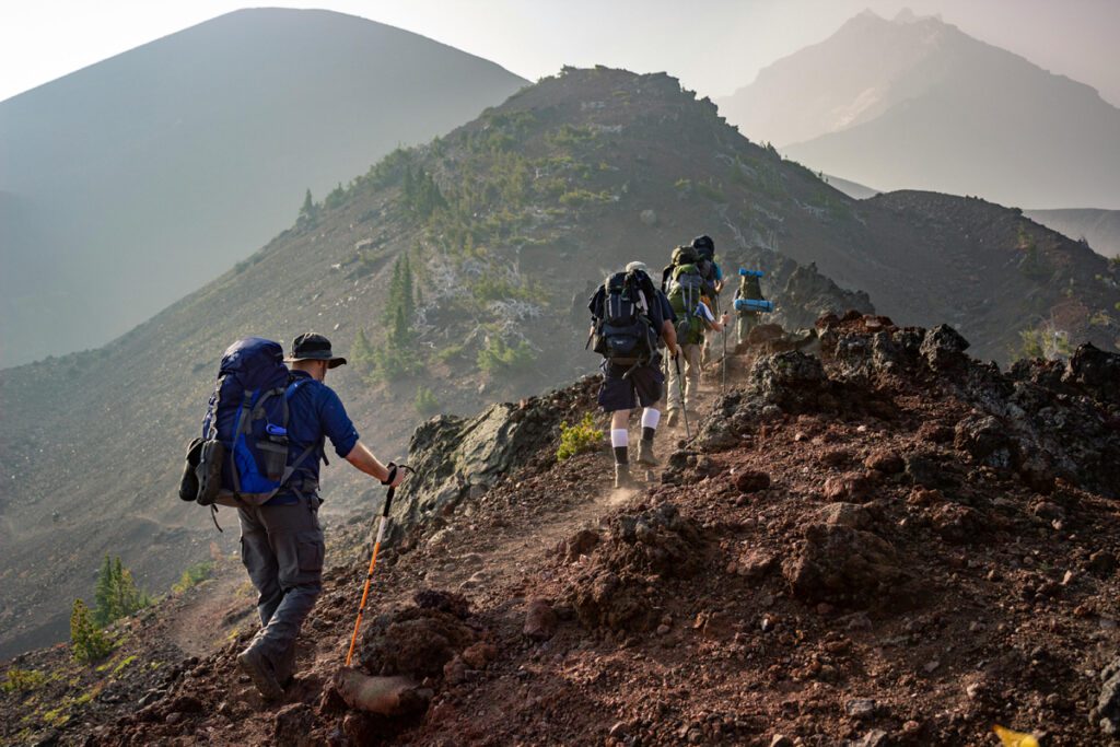 Group of backpackers trekking an upward trail