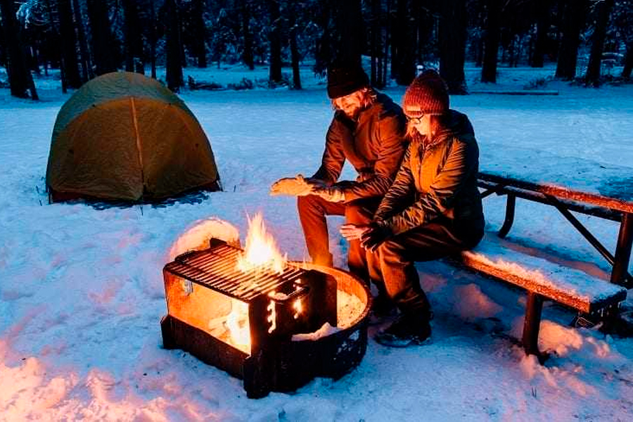 Couple Heating Next To Campfire