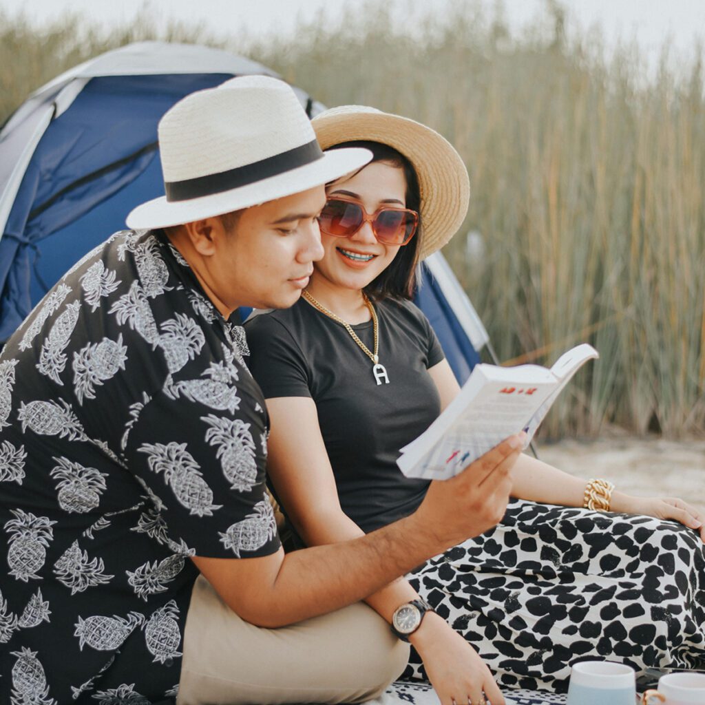 a couple wearing summer camping outfits