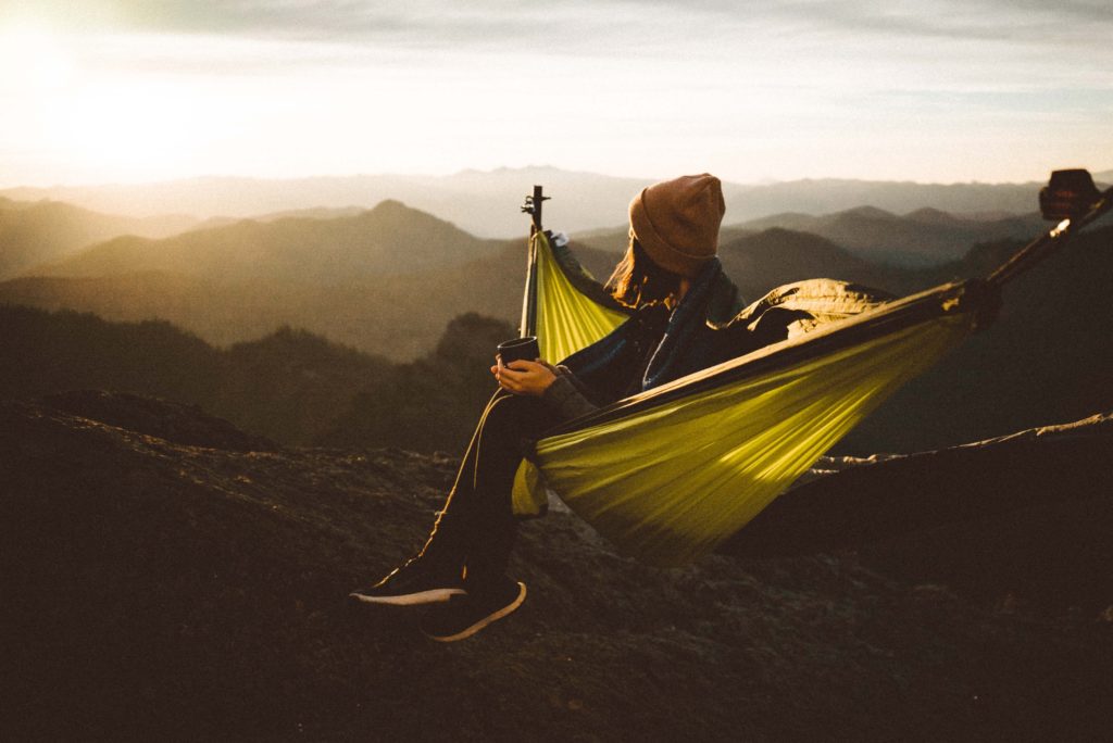 A woman seated on a hammock