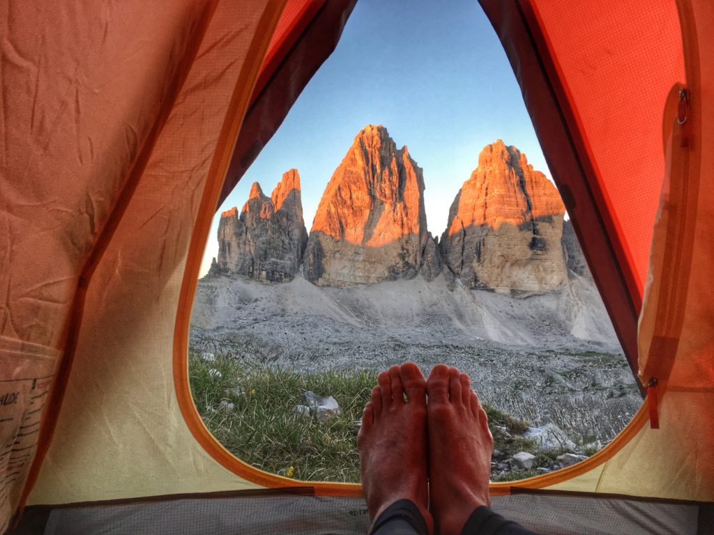 Someone on a sleeping pad inside a tent