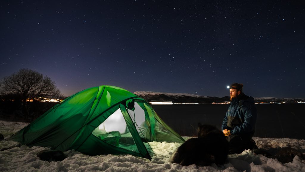 A man and his dog winter camping