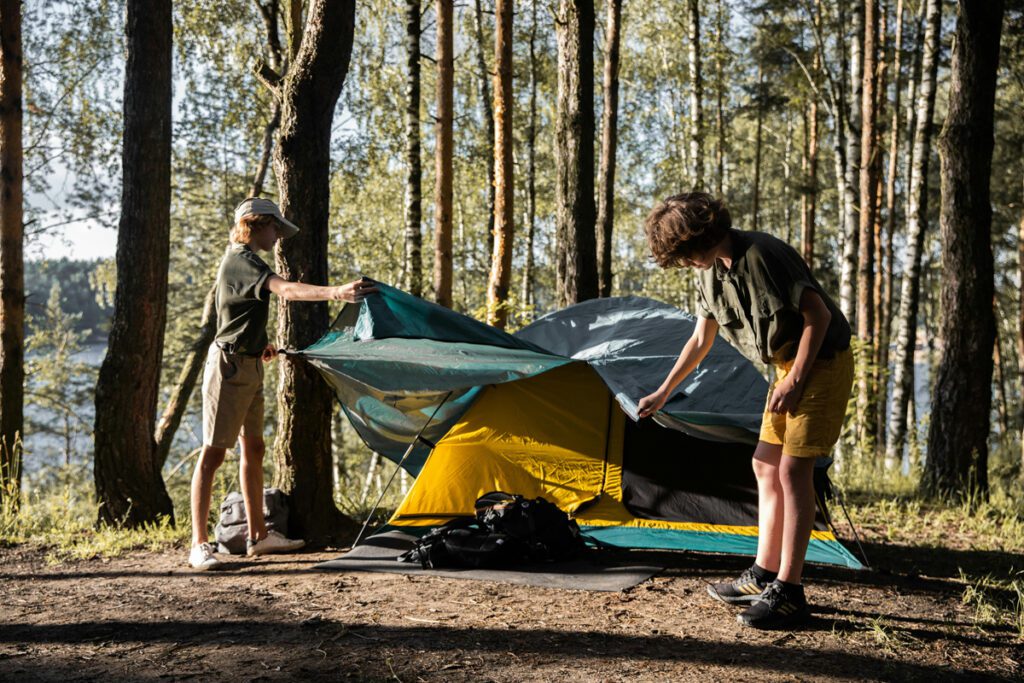 two boys pitching their tent