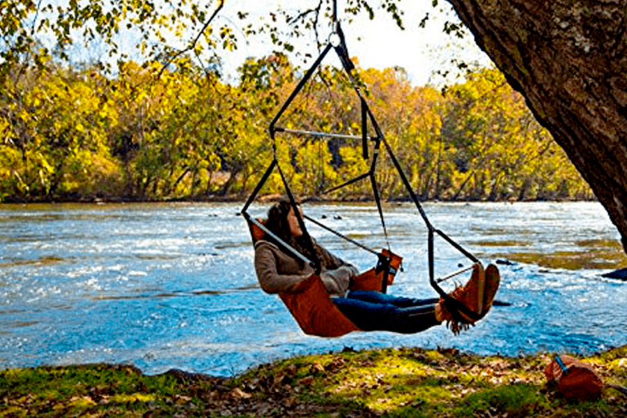 A woman hanging on hammock chair near the lake