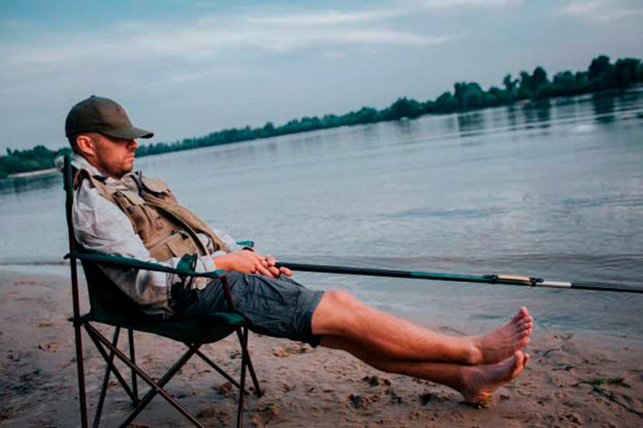 A man fishing with camping chair