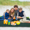 Family beach camping using pocket blanket tarp