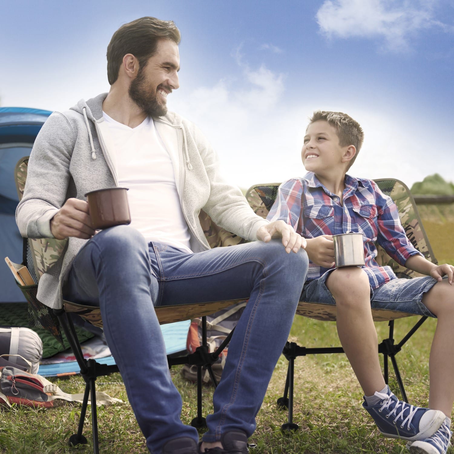 Father and son sitting on a KAMUI camping chair