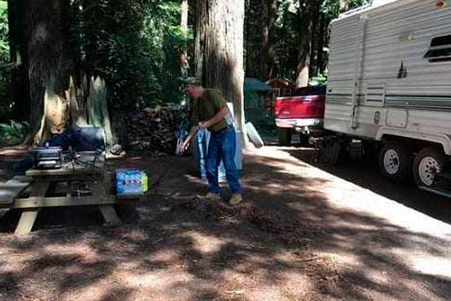 Man Cleaning Campsite