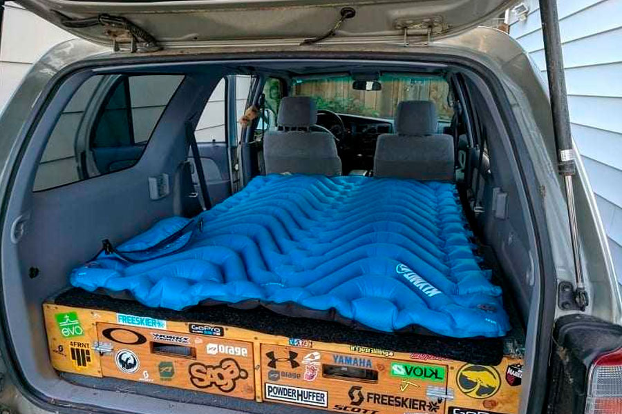 SUV sleeping platform with storage underneath and sleeping pad