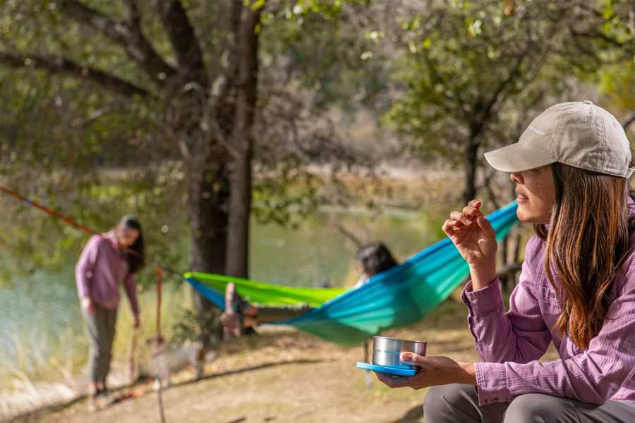 woman camping with hammock