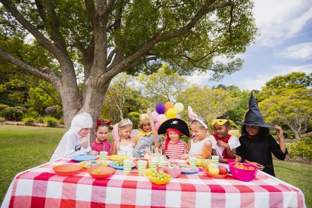 Kids in Costumes Enjoying Picnic Birthday Party