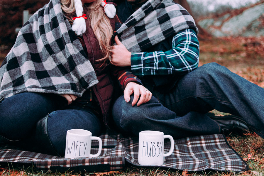 couple sitting on picnic blanket