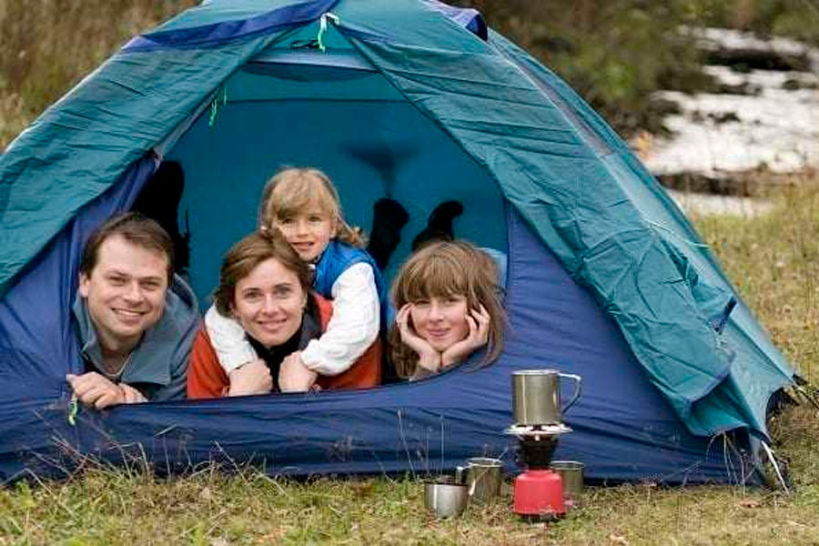 Happy family camping in tent