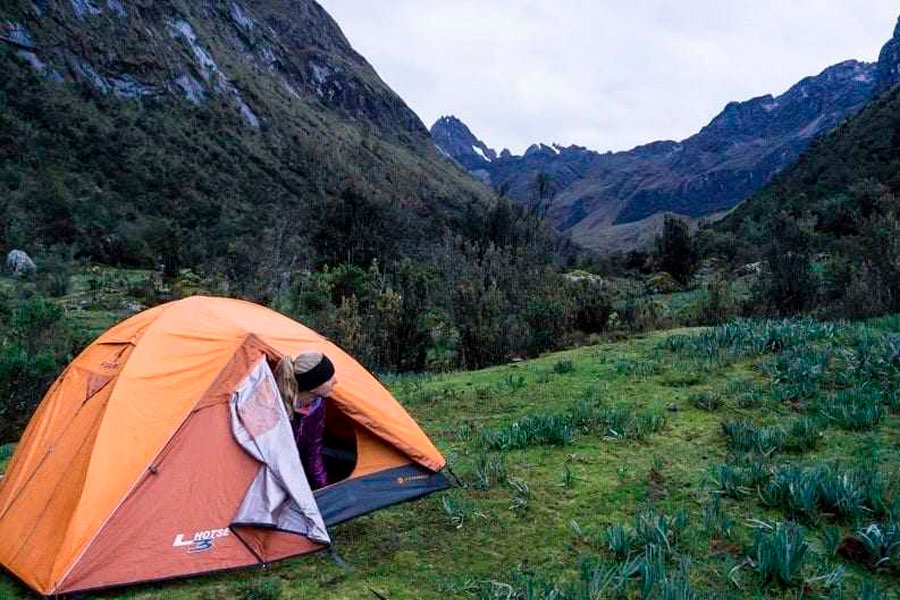 Woman in a tent while high altitude camping