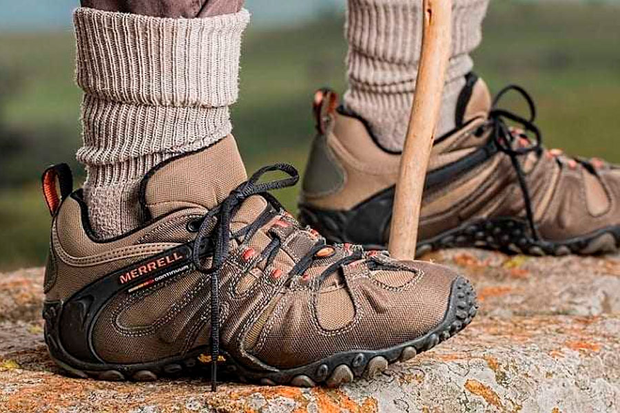 Two Woman Hands Lacing up Trekking Shoes