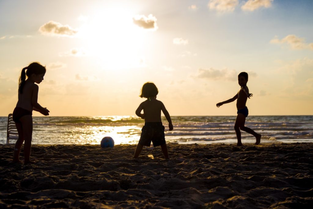 kids playing with ball on beach