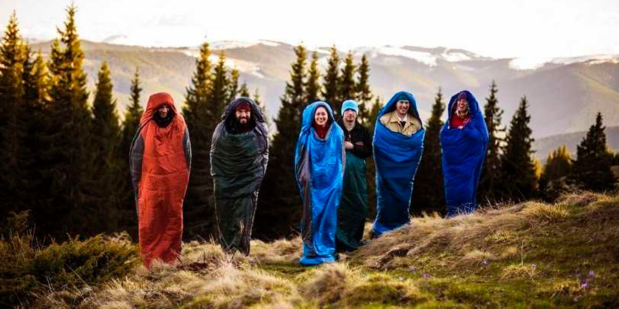 People standing in sleeping bags