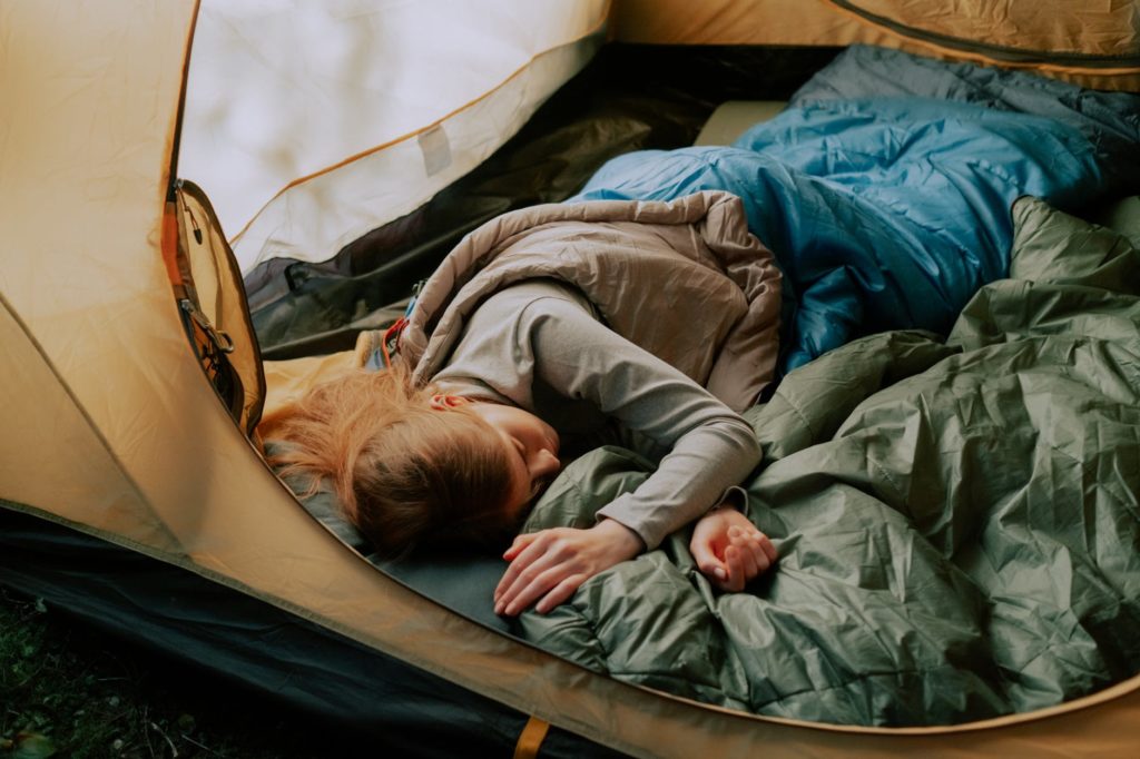 Woman sleeping in a tent