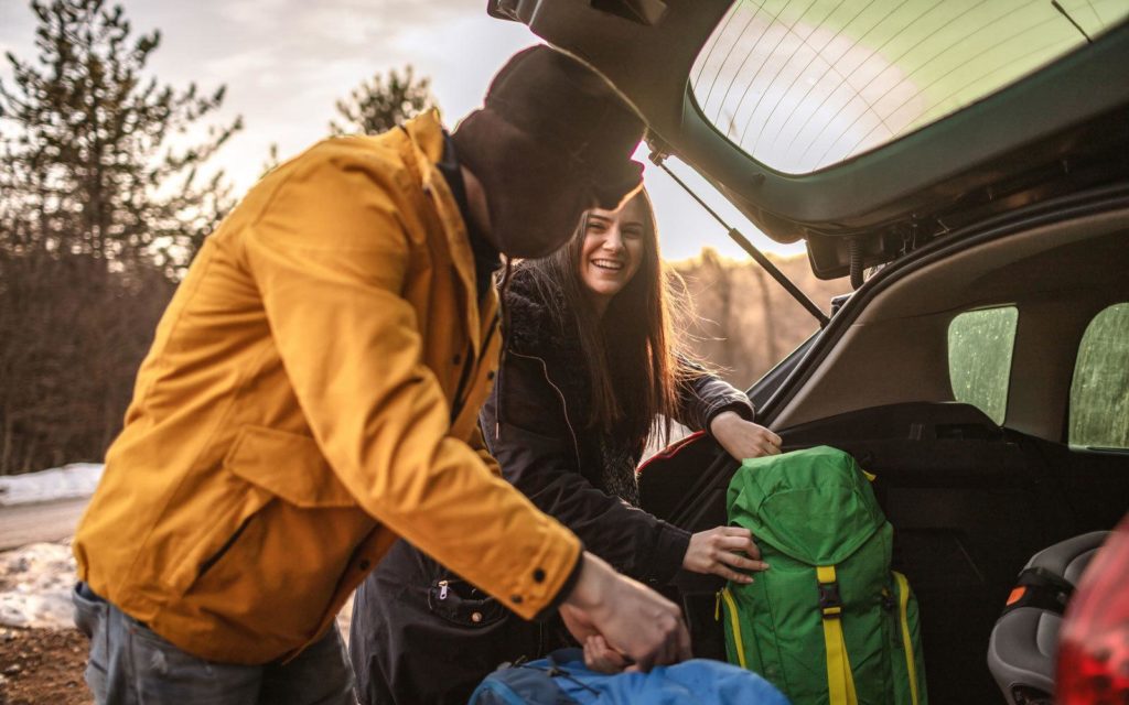 Couple Packing a Car For Camping