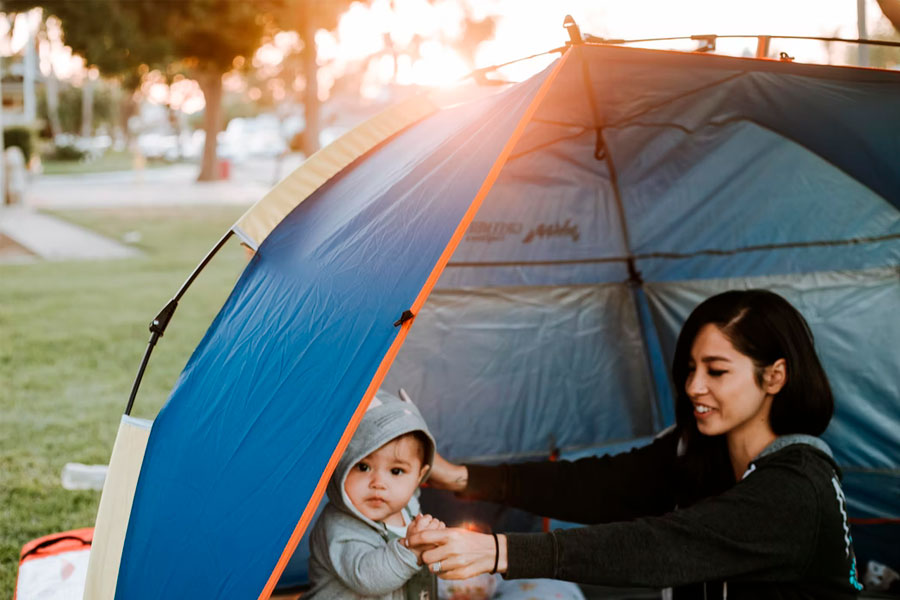 woman and baby in tent
