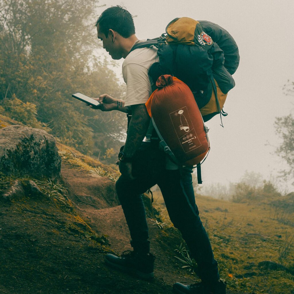 a man hiking with a backpack and camping gear 