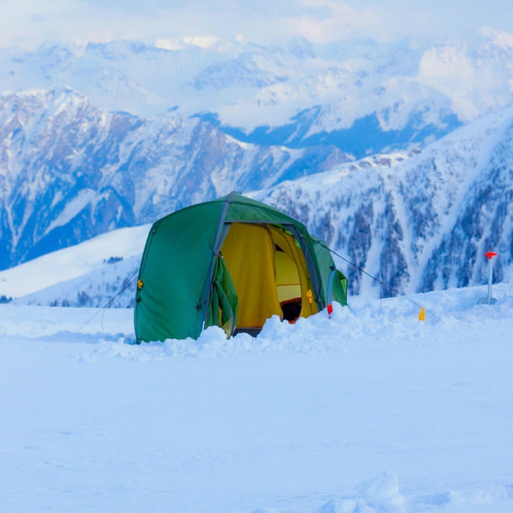 a tent pitched in the middle of a snow