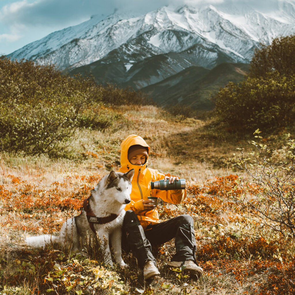 A man and his dog while resting to drink water