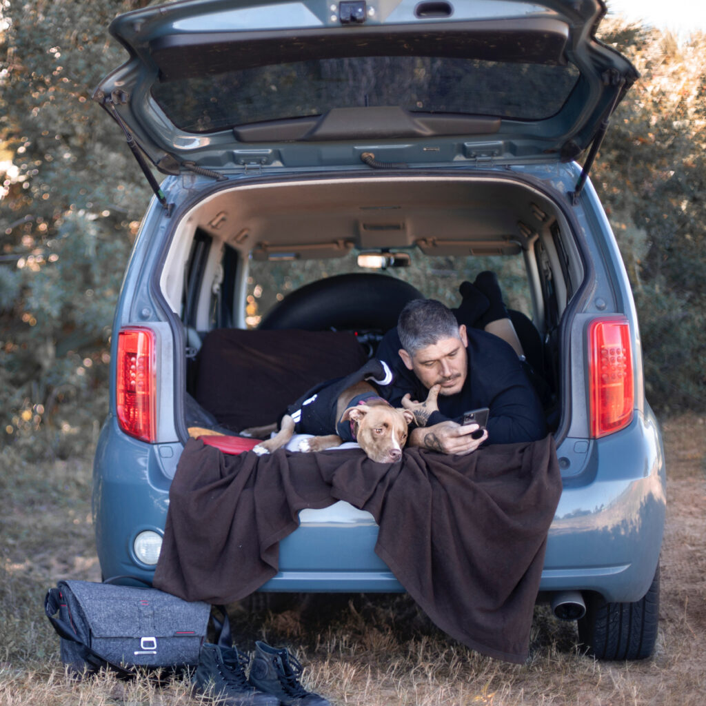 A man camping in a car