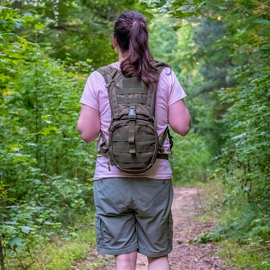 A woman carrying a KAMUI Hydration Backpack