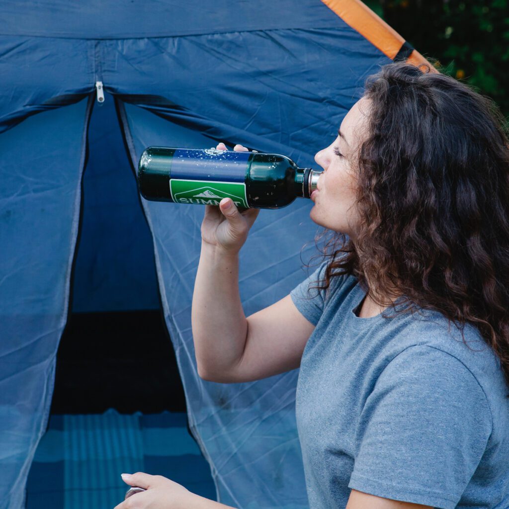 Camping Hydration-A woman drinking from a water bottle