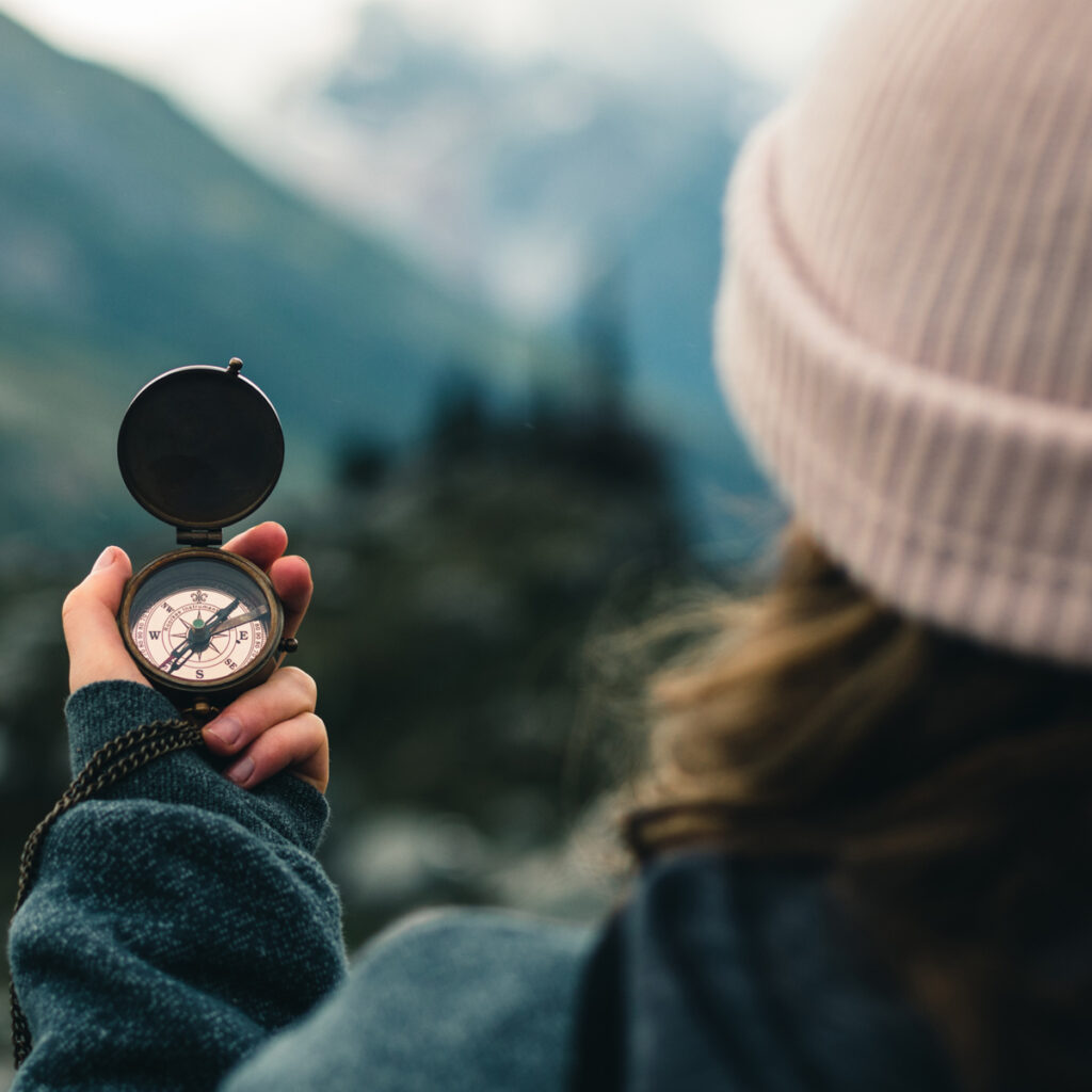 Lady using a compass while outdoors