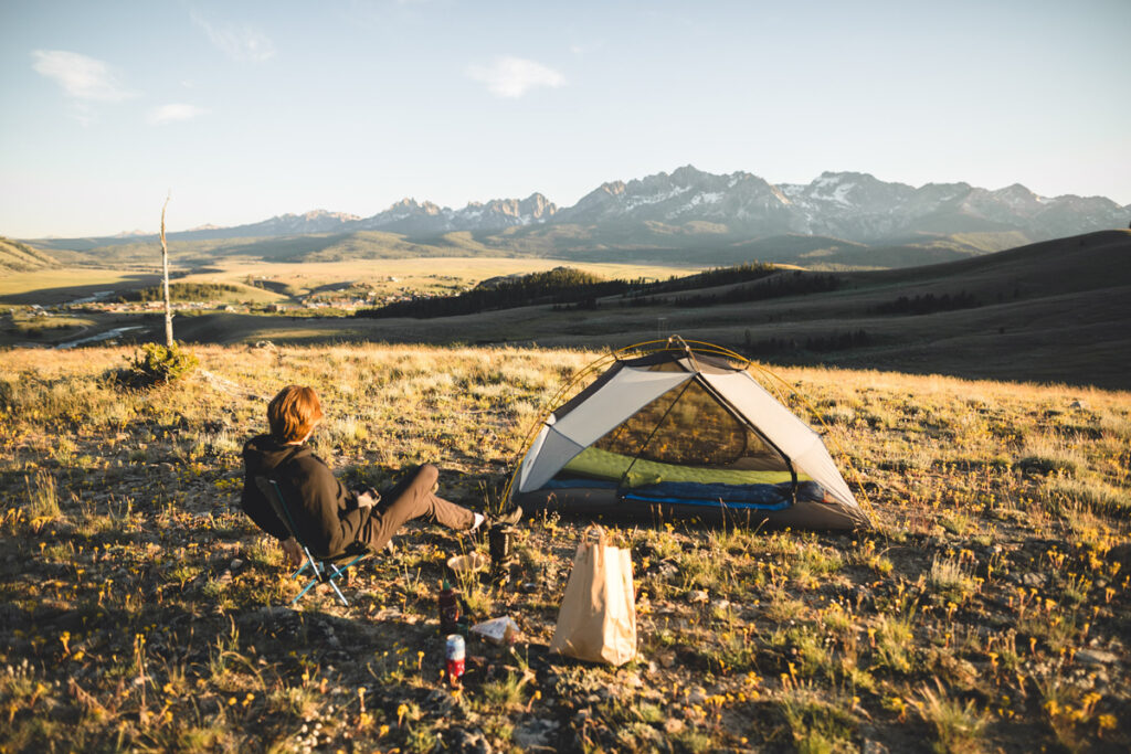 A man camping with a tent a sleeping setup