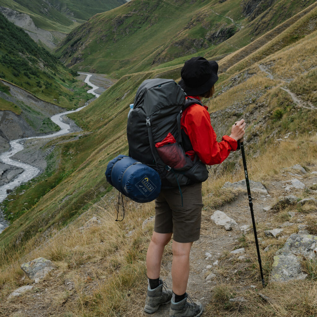 A backpacker traversing a mountain