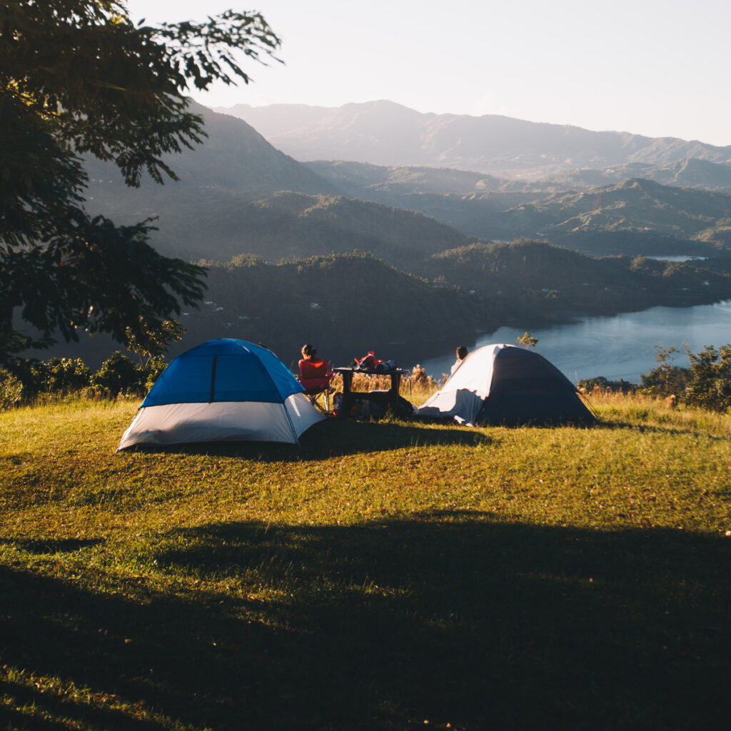 A couple of tents pitched on high ground - tips for camping in the rain