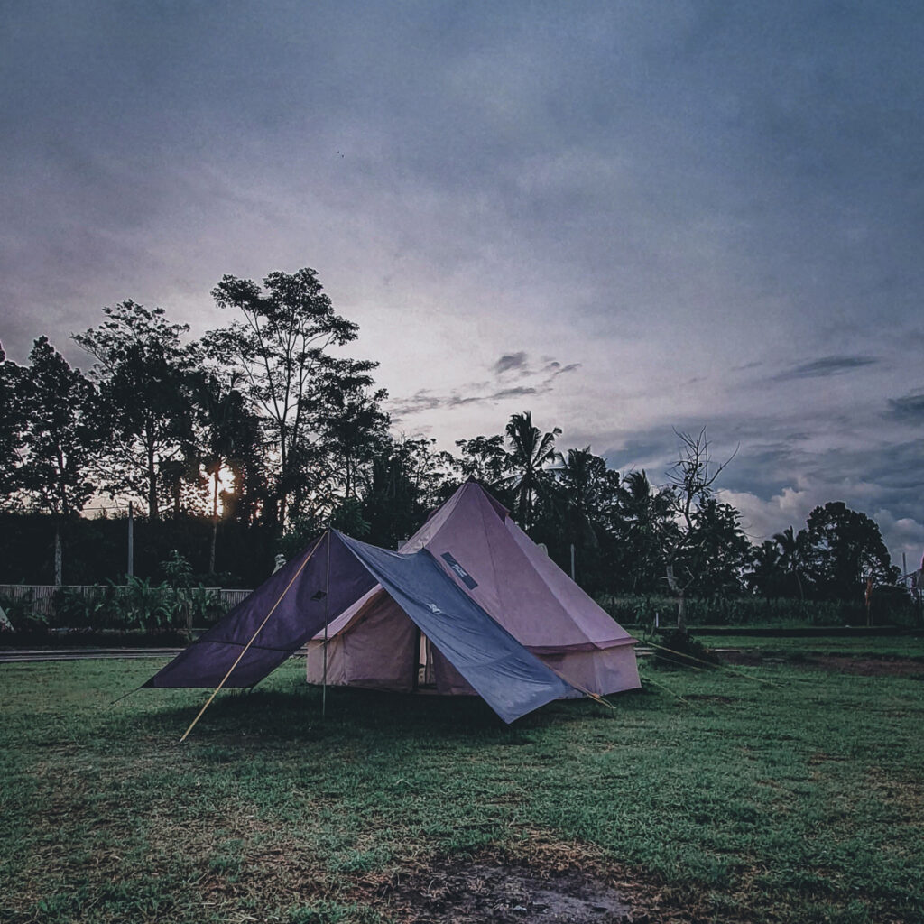 A tarp setup beside a tent - tips for camping in the rain