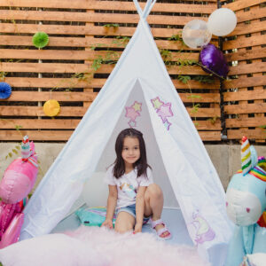 A little girl inside a cute tent for kids