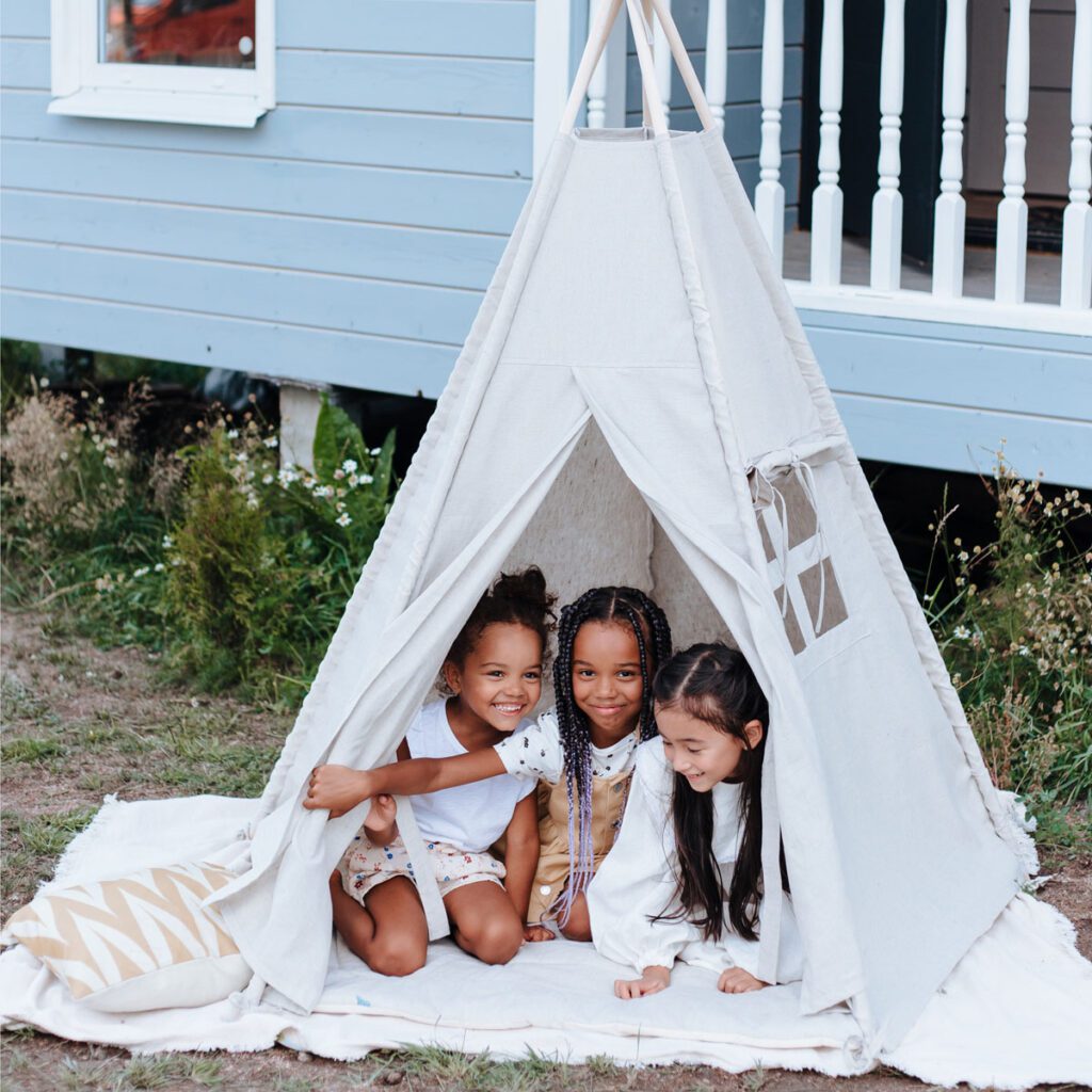 Three kids inside a tent