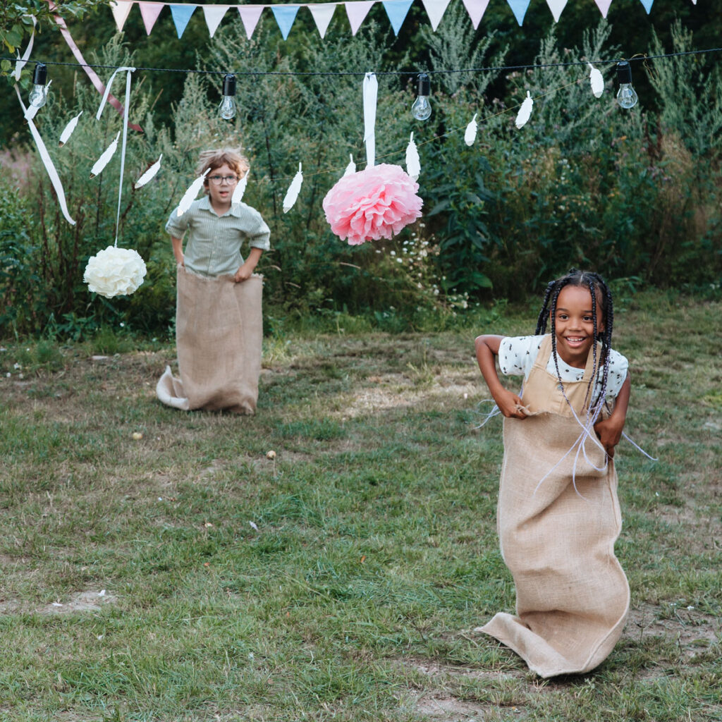 Two kids playing sack race