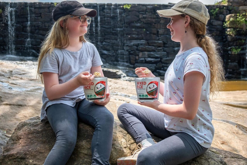 Two young girls enjoying KAMUI Mixed Rice