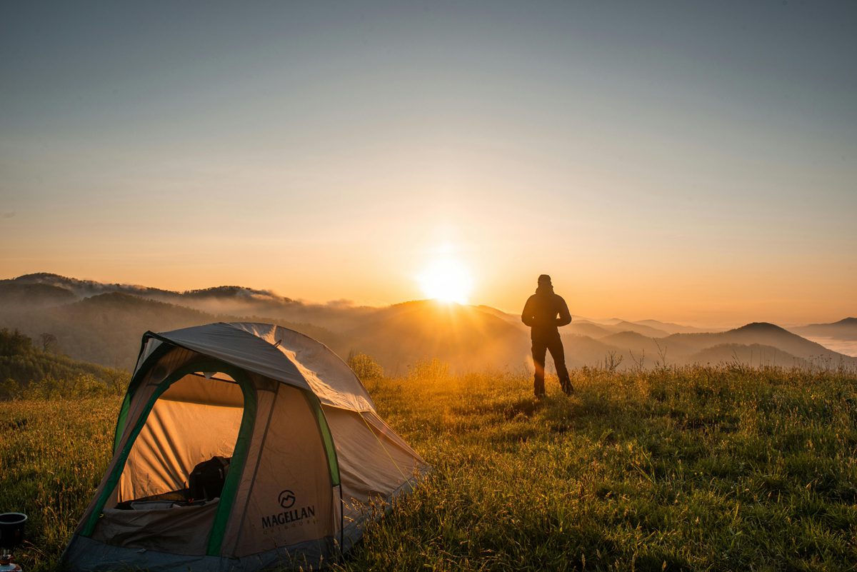 A lady camper enjoying the sunrise