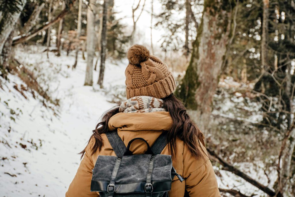 A woman walking on a trail in winter