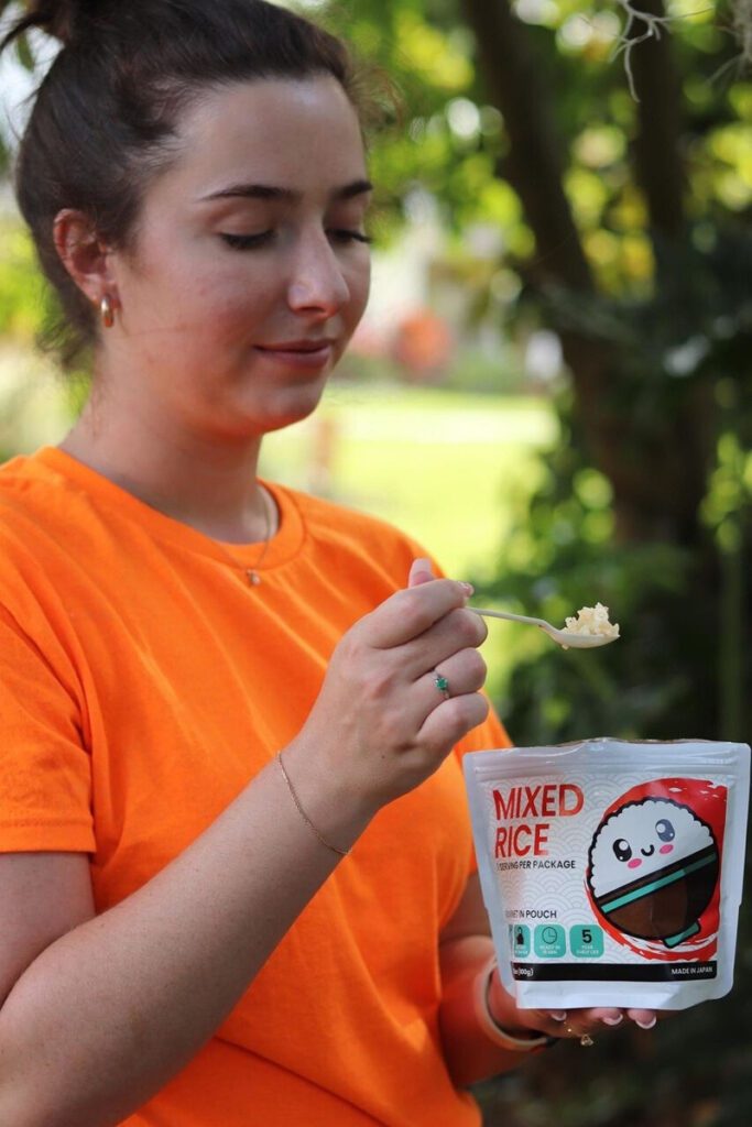 a lady tasting the KAMUI Mixed Rice