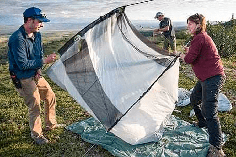 a couple pitching their tent