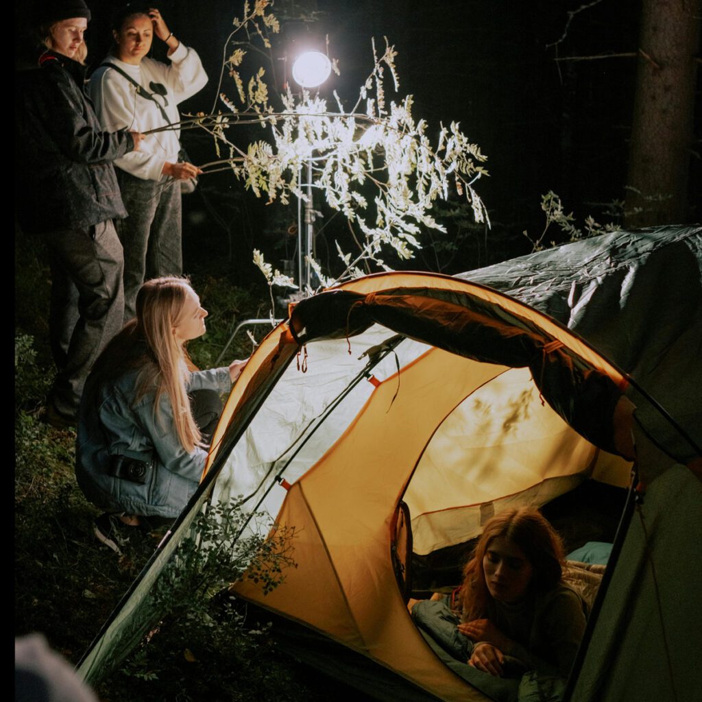 A small group of youngsters in their camp during the nigh